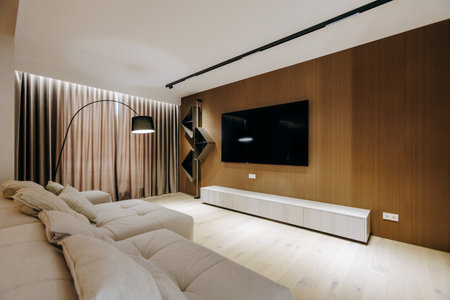 A cozy living room with a comfy couch and a wallmounted TVの写真素材