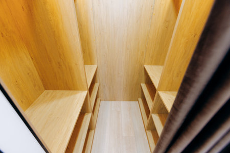 A spacious modern closet with beautifully crafted wooden shelves for organization