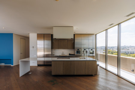 A Modern Kitchen Interior featuring Large Windows with Sleek and Contemporary Designの写真素材