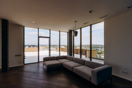 Contemporary Style Modern Living Room Featuring Panoramic Windows and a Stylish Sofa Setの写真素材