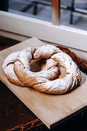 Enjoy the delightful Artisan Twisted Bread beautifully presented on a Wooden Boardの写真素材