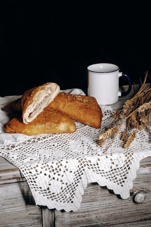 Delightful and Delicious Rustic Baked Goods Accompanied by Fresh Coffee on a Charming Vintage Tableの写真素材