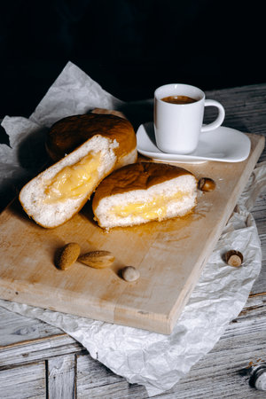 Indulge in our delicious and delightful creamfilled buns, best enjoyed with coffee and nutsの写真素材
