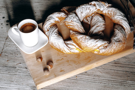 Enjoy Freshly Baked Pastry and Delicious Coffee on a Wooden Board for a Cozy Experience