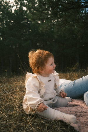 An adorable toddler enjoying the wonders of nature while displaying a cheerful playful expressionの写真素材