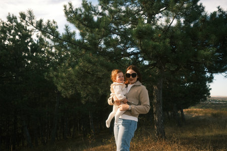 A Mother and Her Child Joyfully Embracing the Wonders of Nature in a Serene Settingの写真素材