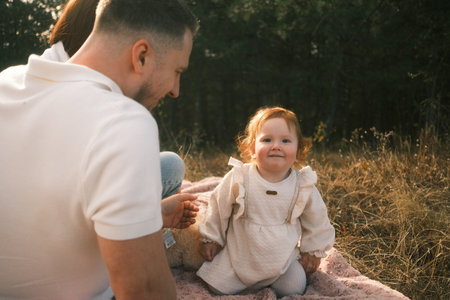 A Joyful Family Moment in Nature Unfolding with a Happy Child Full of Life and Wonderの写真素材