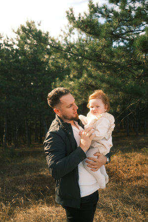 A heartwarming moment shared between a father and his daughter amidst the beauty of natureの写真素材