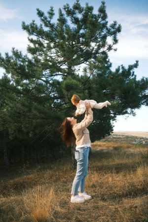 A Joyful and Uplifting Moment Shared Between a Loving Mother and Her Child in Natureの写真素材