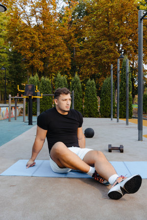 Outdoor Fitness Routine A Man Engaging in Exercising Activities Amidst Beautiful Nature