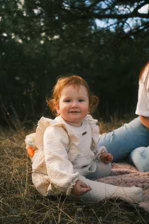Charming Toddler Happily Smiling in Nature Surrounded by a Playful and Colorful Styleの写真素材