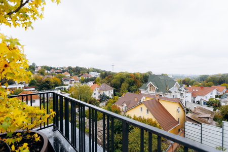 A Beautiful Autumn View from a Cozy Balcony That Overlooks a Scenic and Inviting Neighborhoodの写真素材