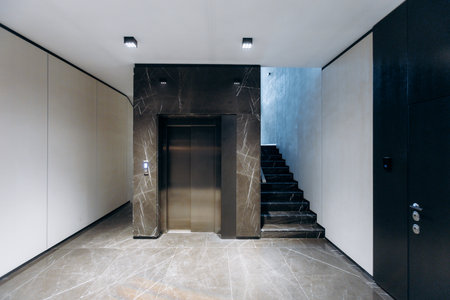 A Modern Elevator Hallway designed with a Minimalistic Aesthetic, showcasing simplicity and eleganceの写真素材
