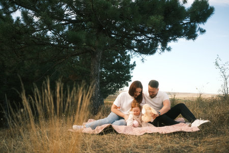 Embracing a Family Bonding Moment Outdoors in Nature while Enjoying Time with the Baby