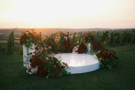 romantic floral setting illuminated at dusk, vibrant rose decorated stage under warm sunset hueの写真素材