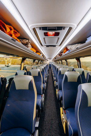 Modern bus interior equipped with emergency lighting and speakerの写真素材