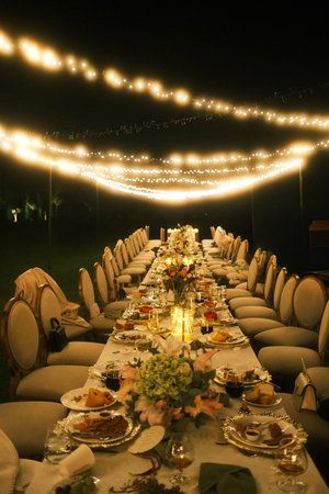 sophisticated feast with floral accents, charming evening table arrangement with lighting and decor