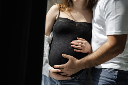 Maternal strength captured through dramatic high contrastの写真素材