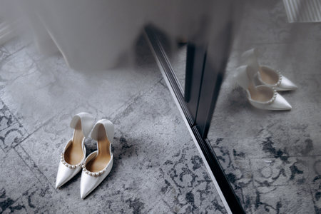 Morning glow highlights graceful shoes and delicate bridalの写真素材