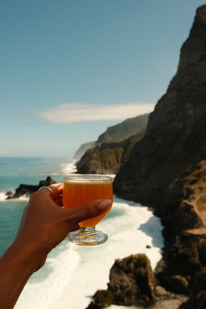 Individual capturing vibrant seaside scene with waves crashingの写真素材