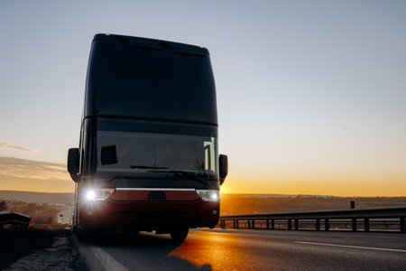 Golden hour scene captures approaching coach and safety emphasisの写真素材