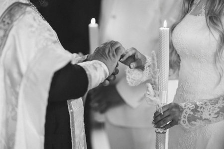 Intimate moment of exchange during religious wedding ceremonyの写真素材