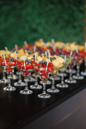 Vibrant assortment of layered sweets and fruit skewers for event