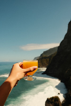 Relaxed traveler enjoying fresh drink overlooking ruggedの写真素材