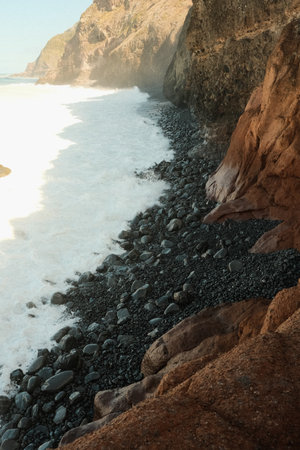 Vivid portrayal of rugged coast with crashing surf and rocksの写真素材