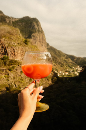 Charming sunset overlooking village with cocktail and tranquilの写真素材