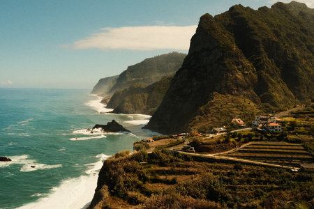 Traditional farmsteads nestled along dramatic seaside cliffsの写真素材