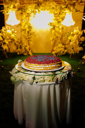 Colorful decorated cake with floral accents and lightingの写真素材