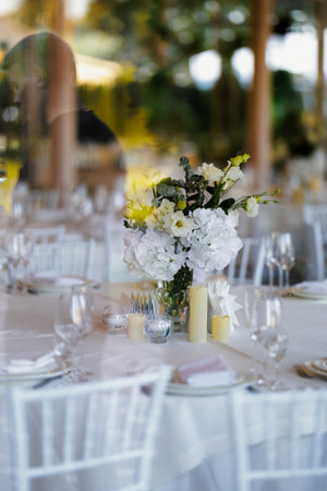 Vertical floral display with white blossoms and draping foliage