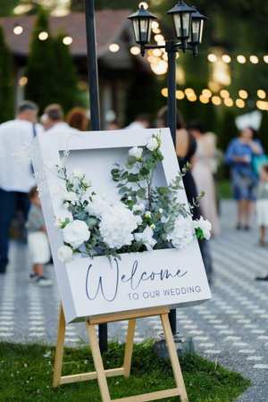 Charming handlettered wedding sign surrounded by greeneryの写真素材