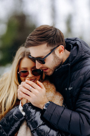 Loving duo dressed for cold weather sharing affectionate momentsの写真素材