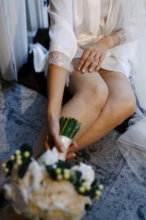 Relaxed bride laying by veil with delicate details visibleの写真素材