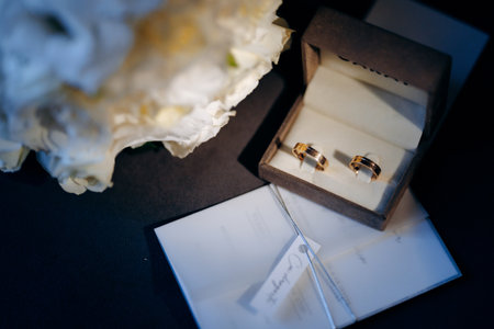 Polished jewelry and petals arranged on intimate scene surfaceの写真素材