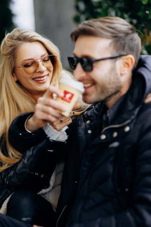 Two creative friends enjoy hot beverages and cheerful smiles