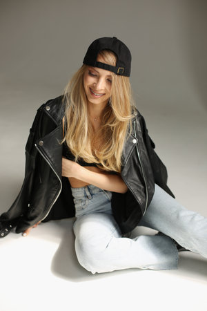 Glamorous woman in denim and jacket showcases laidback style