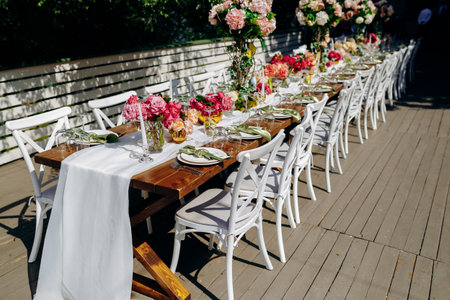 Al fresco event featuring sophisticated table settings and blooms