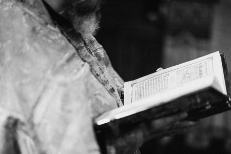 Monochrome depiction of aged religious text with textures