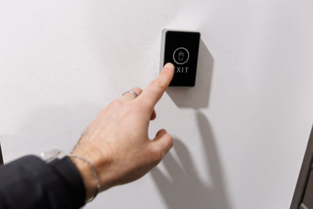 Person activates illuminated sensor on doorの写真素材