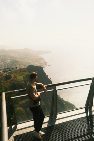 Solitary drive past aged fencing and ocean vistas at sunriseの写真素材