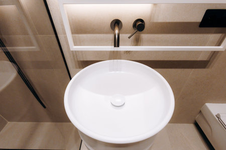 Modern restroom featuring clean lines and warm lighting ambianceの写真素材