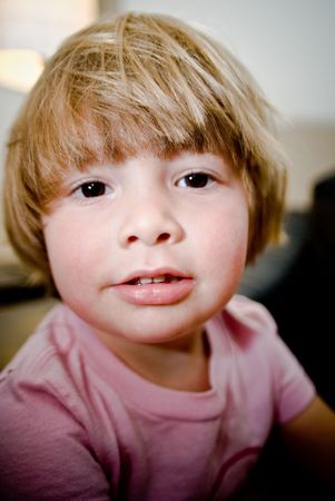 Three year old girl making faces.
