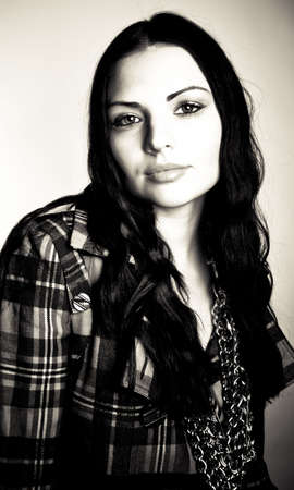 A young model posing in the studio, with styled outfits.