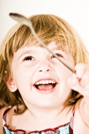 A three year old, girl making faces.の写真素材