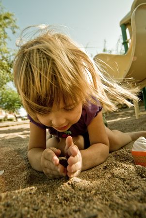 A four year old girl, playing outside.の写真素材