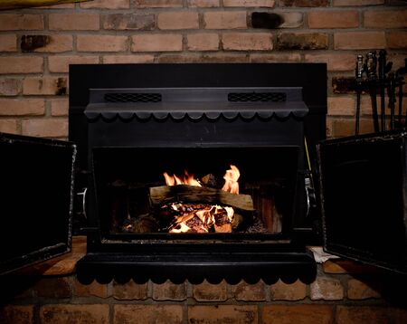 Wood burning fireplace, in a log cabin.