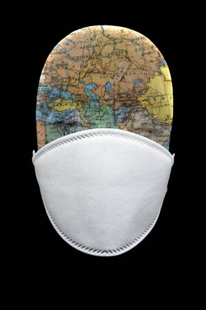 N95 mask with manakin head depicting the globe in black backgroundの写真素材